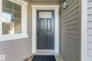 Panel siding exterior with white trim details - 7832 Erasmus Wynd Nw, Edmonton, AB 