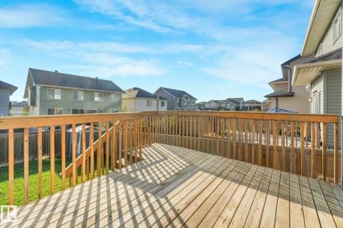 Expansive wood deck with natural wood railing and stairs - 7832 Erasmus Wynd Nw, Edmonton, AB 