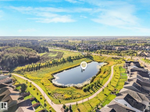 Community featuring a water body, pathways, and green spaces - 7832 Erasmus Wynd Nw, Edmonton, AB 