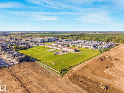 Expansive green space with adjacent residential developments and nearby commercial structures - 7832 Erasmus Wynd Nw, Edmonton, AB 