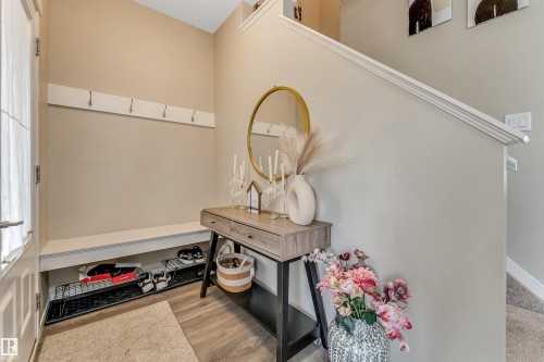 Entryway featuring wood-finish flooring and a built-in bench with storage - 1514 26 Avenue Nw, Edmonton, AB - Indoor Photo Showing Other Room