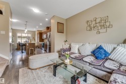 Open-concept living space featuring wood-finish flooring - 