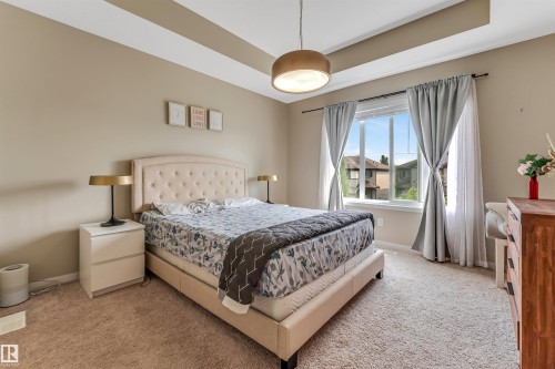 Recessed ceiling with a central pendant light fixture - 1514 26 Avenue Nw, Edmonton, AB - Indoor Photo Showing Bedroom