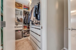 Custom closet system featuring integrated shelving, hanging rods, and pull-out drawers - 
