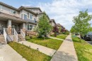 Modern townhome exterior featuring multi-toned siding, stone accents, and a covered porch entry - 1514 26 Avenue Nw, Edmonton, AB  - Outdoor With Facade 