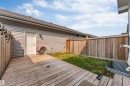 Backyard features a wooden deck, a wooden privacy fence, and a grass area - 1514 26 Avenue Nw, Edmonton, AB  - Outdoor With Deck Patio Veranda With Exterior 