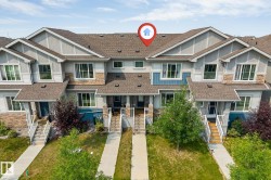 Townhome exterior featuring varied siding, stone accents, and multiple windows - 