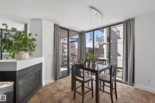 #701 10028 119 St Nw, Edmonton, AB - Indoor Photo Showing Dining Room With Fireplace