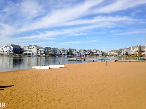 Sandy beach area with waterfront access, multiple docks, and water-facing residences - 1839 80 Street Sw, Edmonton, AB 