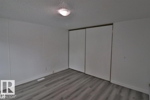 Wood-finish flooring, white walls, and a ceiling-mounted light fixture - 98 Willow Park Estates, Leduc, AB 