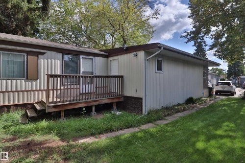Wood deck with railing, steps, and siding exterior - 98 Willow Park Estates, Leduc, AB 