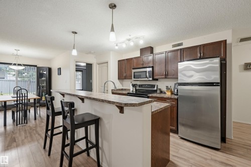 #121 17415 99 Av Nw, Edmonton, AB - Indoor Photo Showing Kitchen With Stainless Steel Kitchen With Upgraded Kitchen