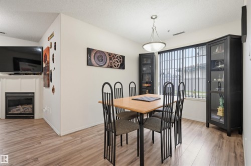 #121 17415 99 Av Nw, Edmonton, AB - Indoor Photo Showing Dining Room With Fireplace