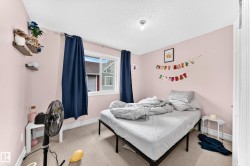 Single window with white trim, light-colored carpeting, white baseboards, and a ceiling-mounted light fixture - 
