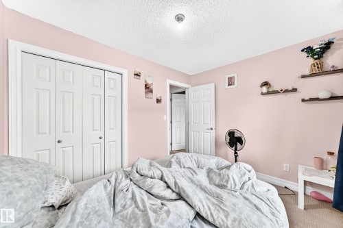 White bi-fold closet doors with knob hardware - #146 655 Tamarack Rd Nw, Edmonton, AB 