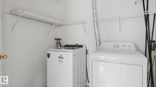 Laundry area featuring a top-load washing machine and a dryer - #107 10153 117 St Nw, Edmonton, AB 
