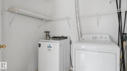 Laundry area featuring a top-load washing machine and a dryer - 