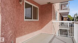 Private balcony with stucco exterior, white window frame, and white railings - 
