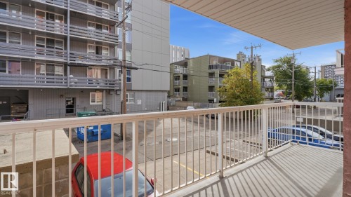 Balcony with a white metal railing and a concrete floor - #107 10153 117 St Nw, Edmonton, AB 