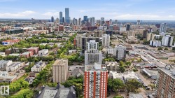 Panoramic urban landscape with a dynamic cityscape featuring diverse architectural styles and extensive green spaces - 