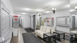 Mailbox wall with individual units, recessed lighting, and tiled flooring - 