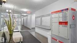 Corridor with recessed lighting, wall-mounted mailboxes, and a parcel locker - 