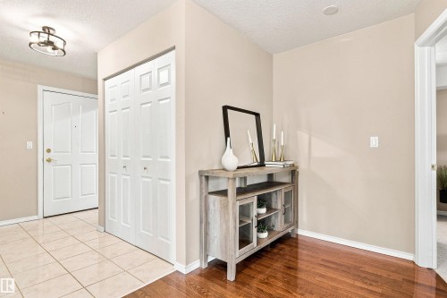 Tile flooring, wood-finish flooring, white panel doors, and a ceiling-mounted light fixture - #432 6703 172 St Nw, Edmonton, AB 