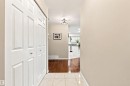 Entryway featuring tile flooring, bi-fold closet doors, and a ceiling-mounted light fixture - #432 6703 172 St Nw, Edmonton, AB 