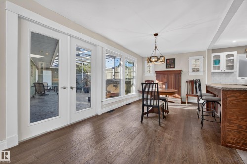 Hardwood-style flooring, white trim, recessed lighting, and a chandelier lighting fixture - 11603 72 Avenue Nw, Edmonton, AB 