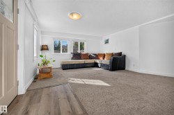 Spacious interior with neutral carpeting and wood-finish flooring - 
