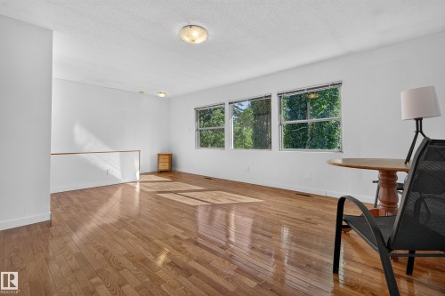 Hardwood flooring throughout, multiple windows, and flush-mount lighting fixtures - 11603 72 Avenue Nw, Edmonton, AB 