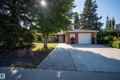 Brick exterior with stone accents, a single-car garage, and a concrete driveway - 11603 72 Avenue Nw, Edmonton, AB 