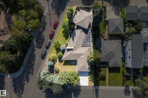 Expansive lot featuring mature trees, a paved driveway, and solar panels - 11603 72 Avenue Nw, Edmonton, AB 