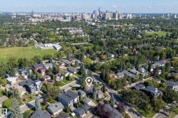 Aerial perspective of a verdant neighborhood with a distant cityscape - 