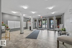 Tiled flooring, overhead lighting, mailboxes, and glass entry doors - 