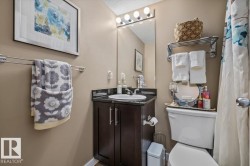 Vanity with dark wood-finish cabinetry, countertop, and an integrated basin - 