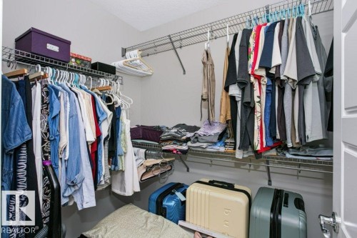 Walk-in closet featuring wire shelving and multiple hanging rods - 3496 Weidle Way Sw, Edmonton, AB - Indoor With Storage