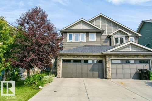 Contemporary property with  garage, stone facade accents, and horizontal siding - 3496 Weidle Way Sw, Edmonton, AB - Outdoor With Facade