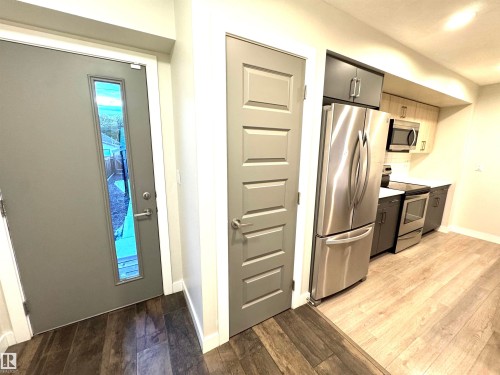 Wood-finish flooring, stainless steel appliances, and two-tone cabinetry - 12046 89 Street Nw, Edmonton, AB 