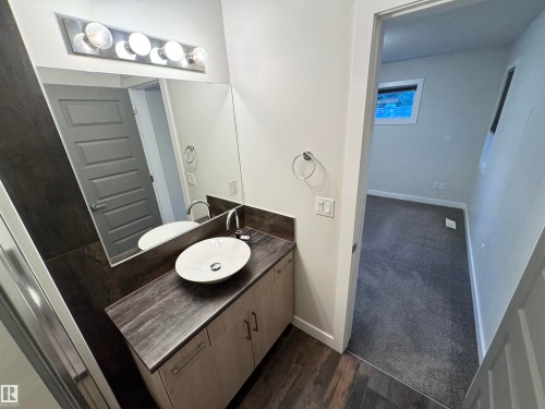 Vanity with a vessel sink, chrome faucet, and integrated storage cabinetry - 12046 89 Street Nw, Edmonton, AB 