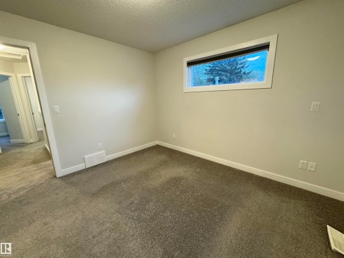 Wall-to-wall carpeting and white trim create a bright interior - 12046 89 Street Nw, Edmonton, AB 
