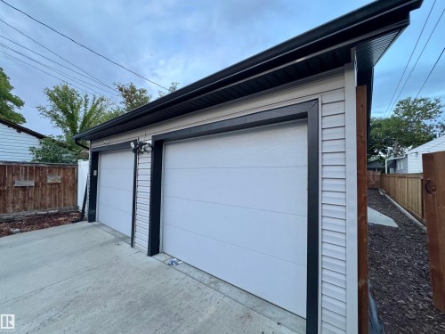 Two-car detached garage featuring horizontal siding and dark trim - 12046 89 Street Nw, Edmonton, AB 