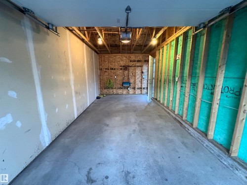 Concrete flooring with overhead lighting, exposed ceiling joists, and partially finished wall surfaces - 12046 89 Street Nw, Edmonton, AB 