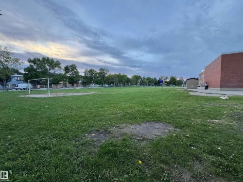 Expansive green space featuring a large grassy area and distant trees - 12046 89 Street Nw, Edmonton, AB 