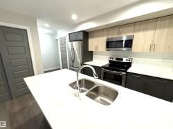 White countertop with a double basin stainless steel sink - 