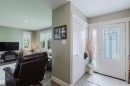 Entryway with leaded glass door and sidelight, featuring a built-in closet with double doors - 14814 104 Avenue Nw, Edmonton, AB 