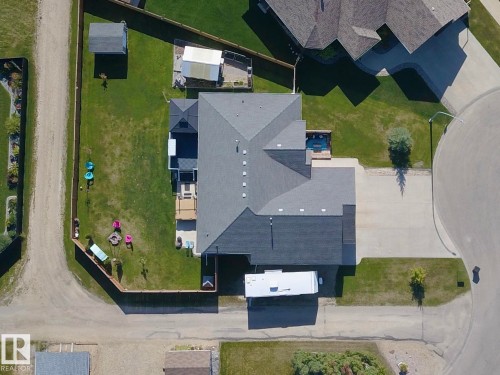 Paved driveway, attached garage, rear deck, fenced backyard, and a detached shed - 6003 50 Ave, Barrhead, AB 