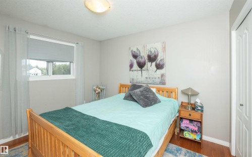 Warm wood-finish flooring with a neutral wall color - 6003 50 Ave, Barrhead, AB 