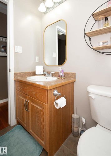 Wood-finish vanity with a built-in sink and polished chrome faucet - 6003 50 Ave, Barrhead, AB 