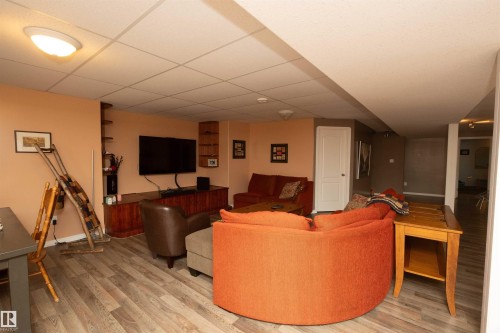 Wood-finish flooring throughout, recessed lighting, and built-in shelving - 6003 50 Ave, Barrhead, AB 